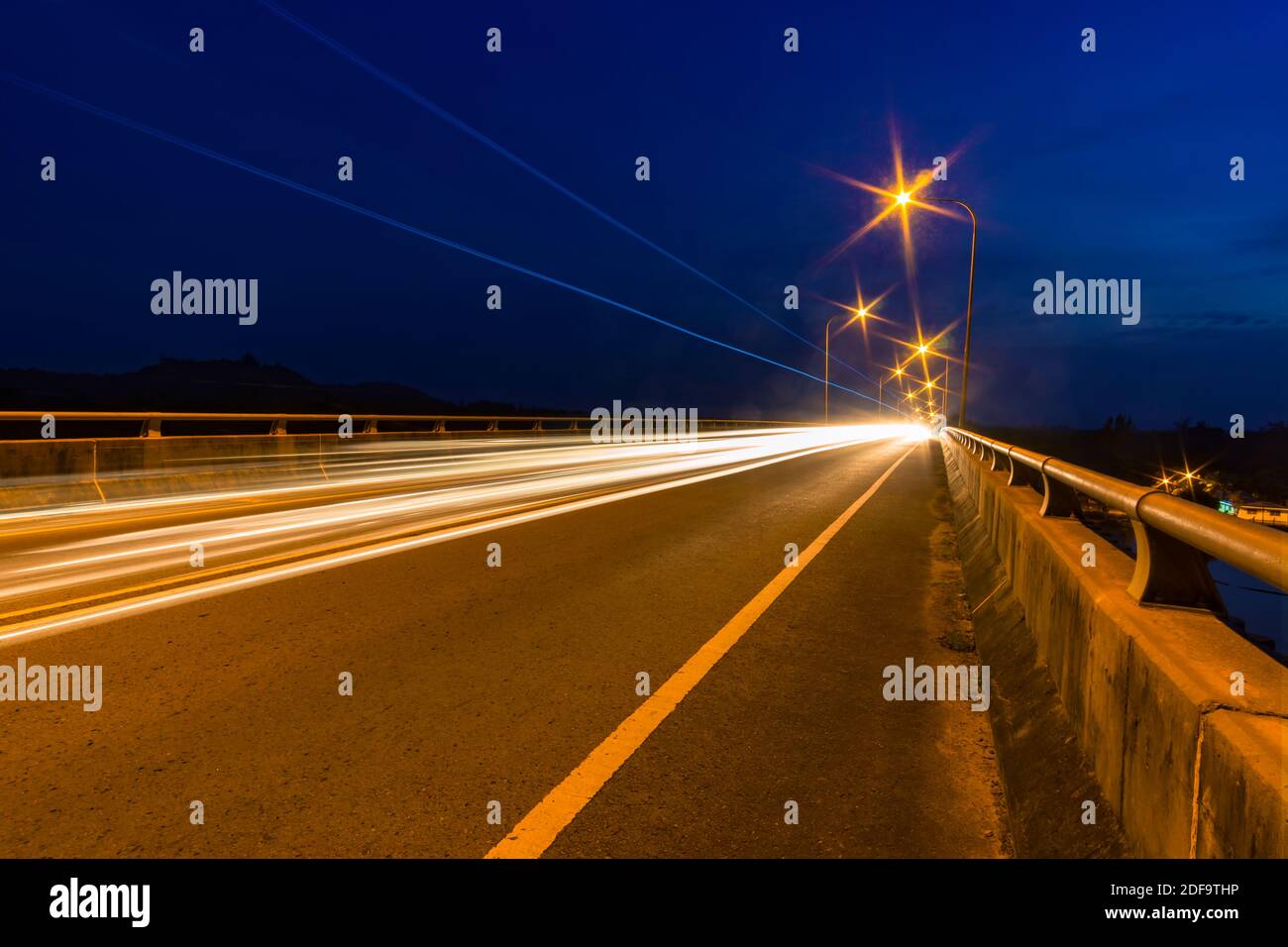 Traffic light trails at night on a bridge Stock Photo - Alamy