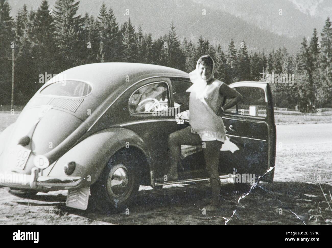 Historical Photo:  A woman with a VW Kaefer car  1963 in Innsbruck, Austria. Reproduction in Marktoberdorf, Germany, October 26, 2020.  © Peter Schatz / Alamy Stock Photos Stock Photo