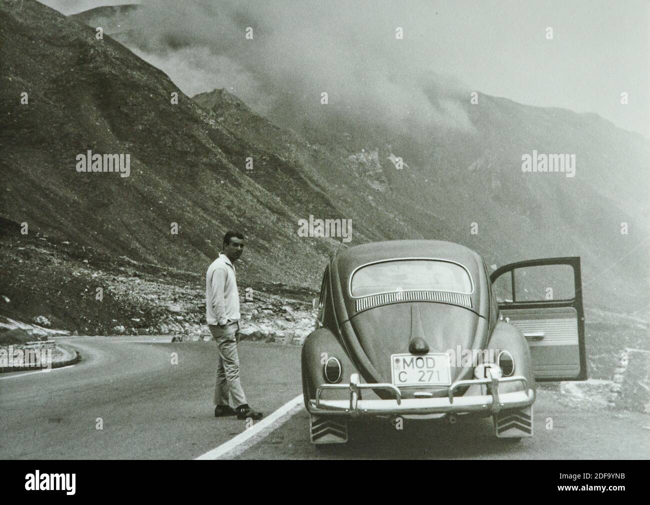 Historical Photo:  A man with a VW Kaefer car  1963 in Innsbruck, Austria. Reproduction in Marktoberdorf, Germany, October 26, 2020.  © Peter Schatz / Alamy Stock Photos Stock Photo