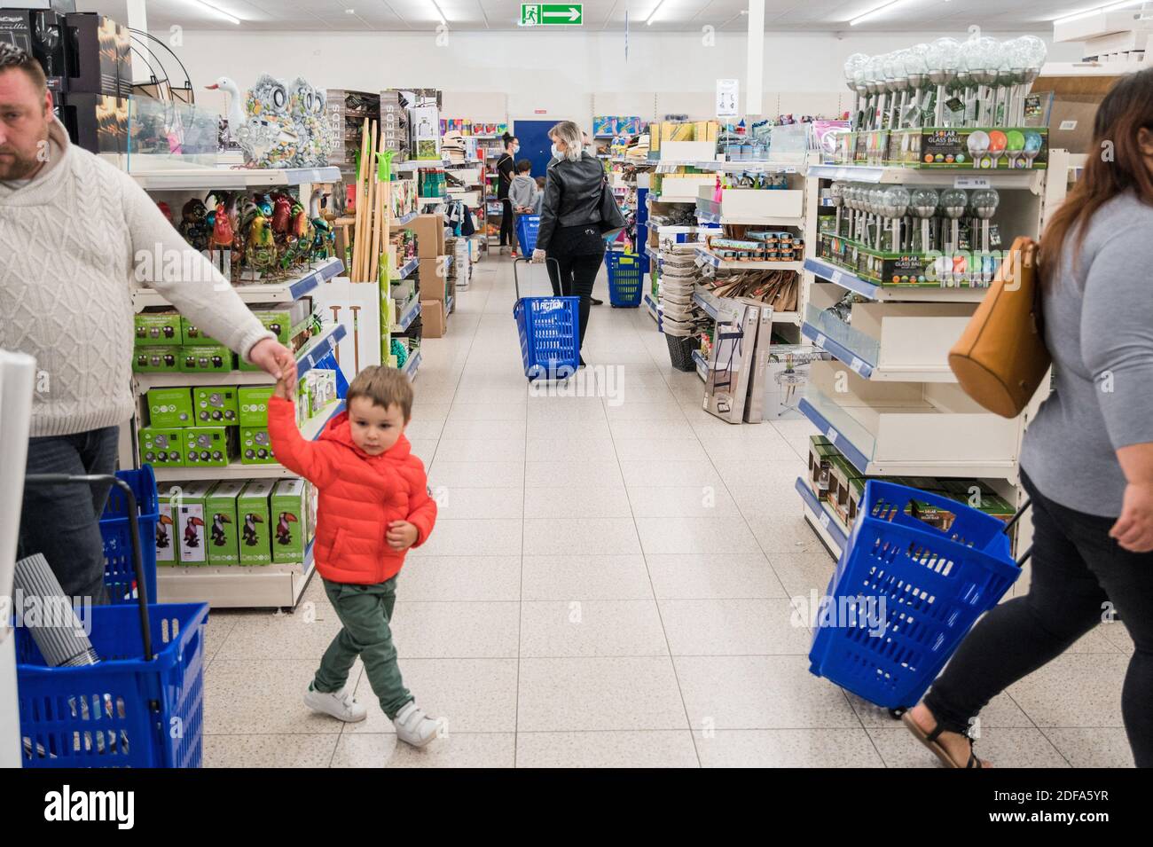 Customers carry trolleys at a Action supermarket on May 15, 2020 in Lambres -lez-Douai near Lens, after a partial lifting of restrictions due to the  Covid-19 pandemic caused by the novel coronavirus came