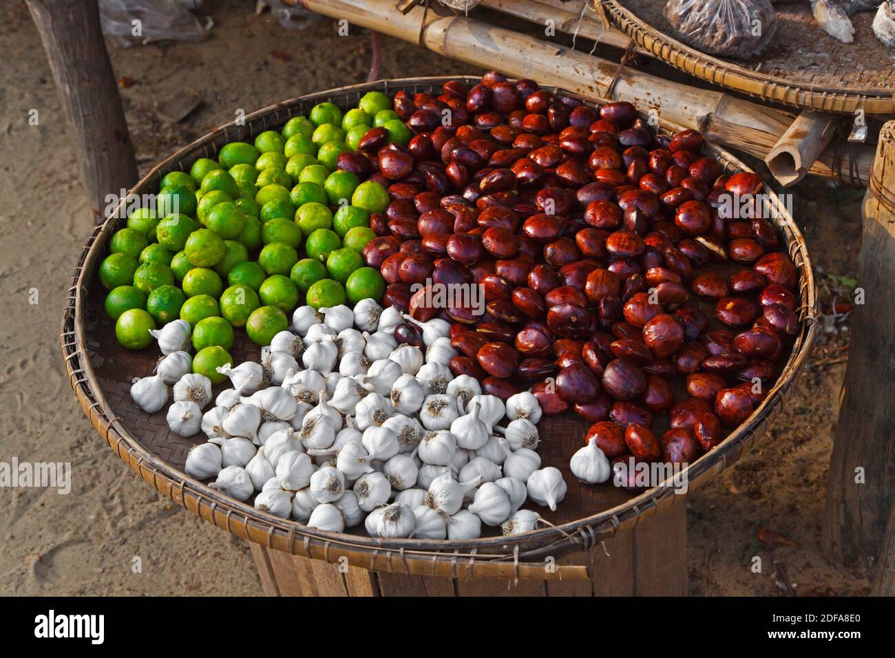 GARLIC, LIMES and WATER CHESTNUTS are offered for sale at the market in NEW BAGAN - BAGAN, MYANMAR Stock Photo