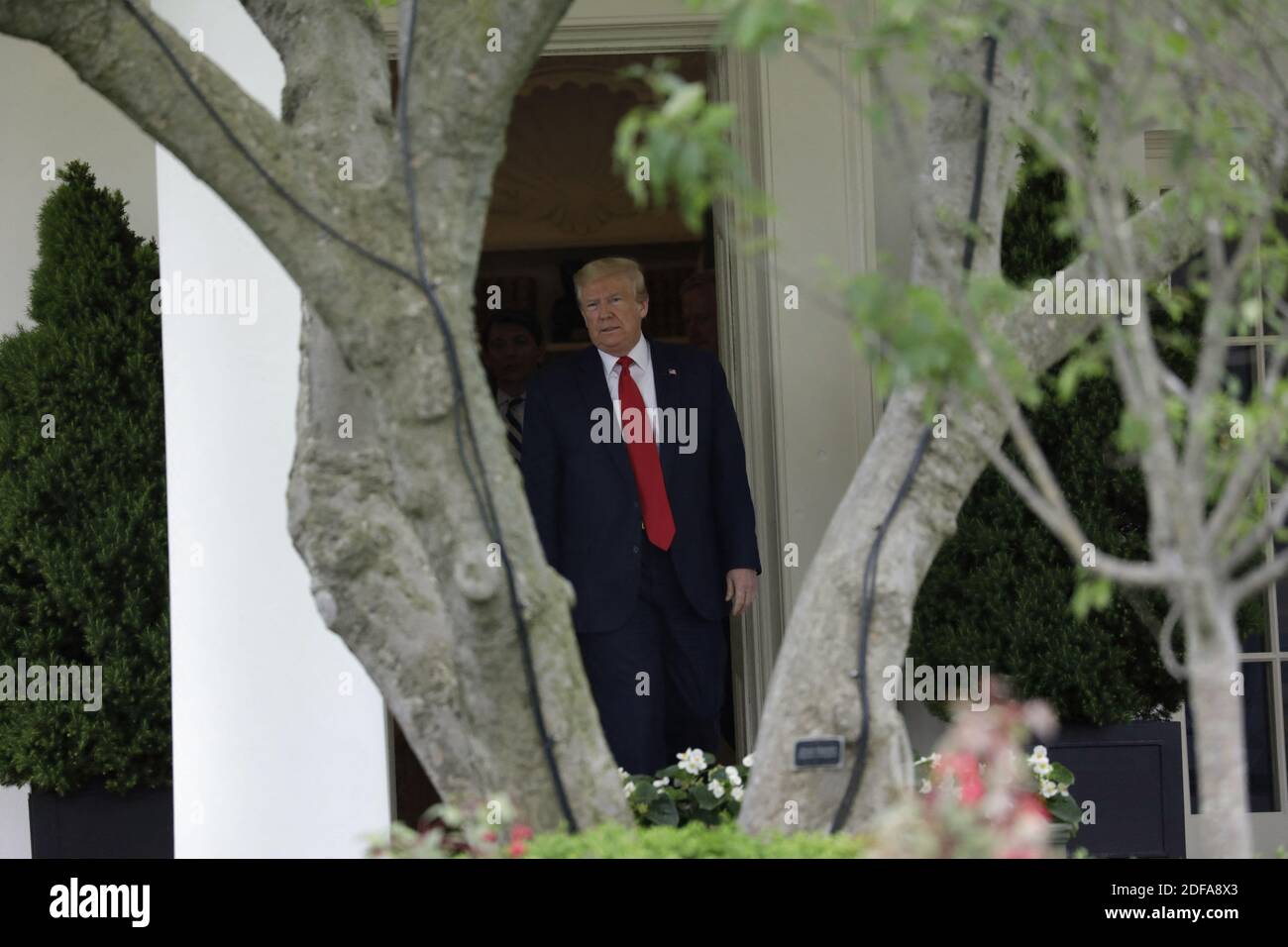 U.S. President Donald Trump walks out from the Oval Office of the White ...