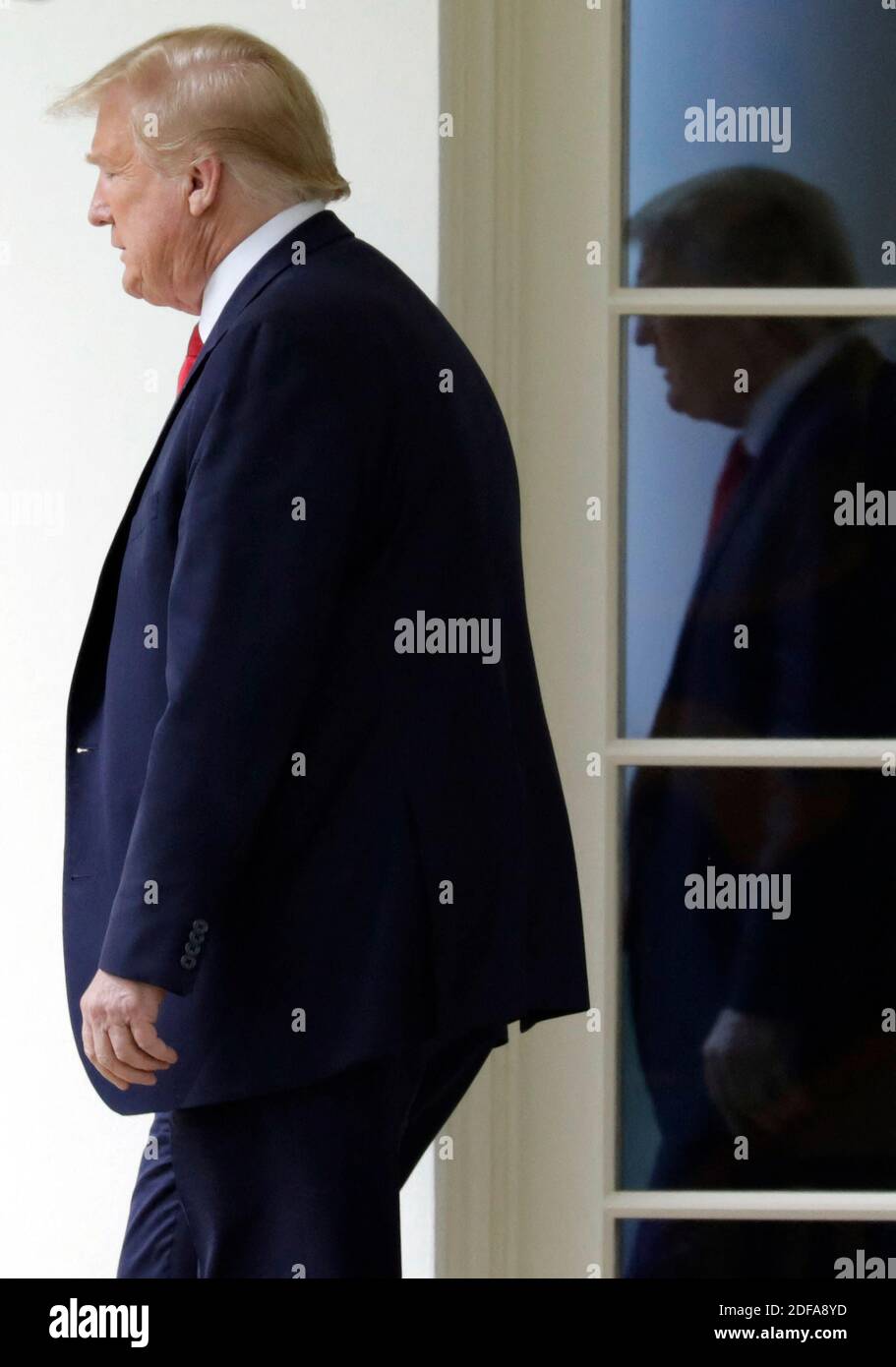 U.S. President Donald Trump walks out from the Oval Office of the White ...