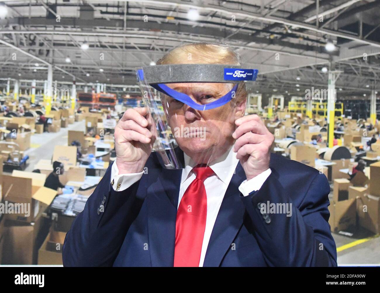 NO FILM, NO VIDEO, NO TV, NO DOCUMENTARY - President Trump looks through a face shield, in front of poster of the manufacturing of these shields, while touring Ford Motor Co.'s Rawsonville Components Plant in Ypsilanti, MI, USA on Thursday, May 21, 2020. Trump says he wore a mask in a 'back area' during a factory tour in Michigan, but removed it before facing the cameras. He told reporters he took off the facial covering at the Ford car plant because he 'didn't want to give the press the pleasure of seeing it', and he was about to make a speech. Photo by Daniel Mears/The Detroit News/TNS/ABACA Stock Photo