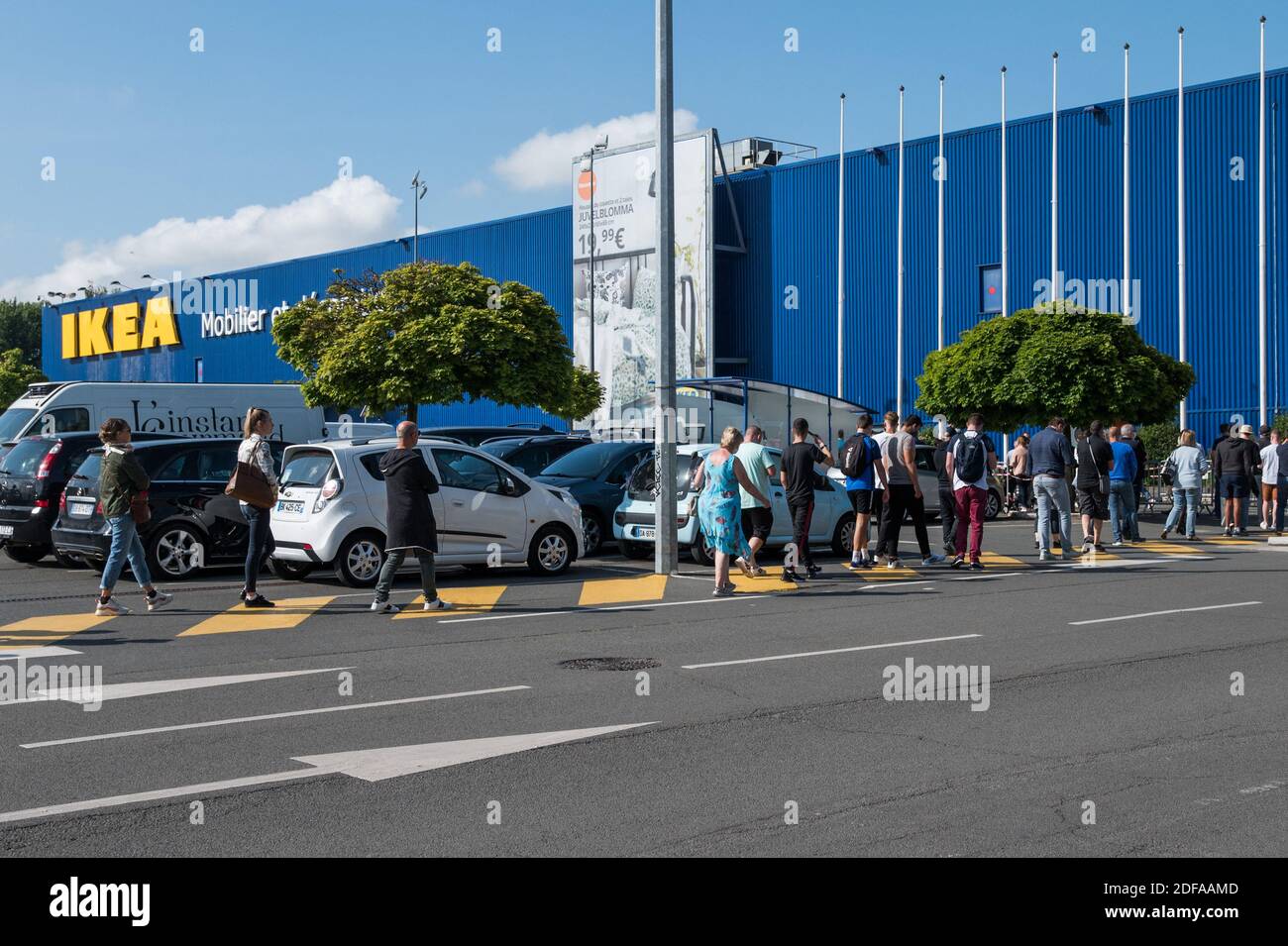Customers wait in line as Ikea shop reopens on May 25, 2020 in Lomme near  Lille, after a partial lifting of restrictions due to the Covid-19 pandemic  caused by the novel coronavirus
