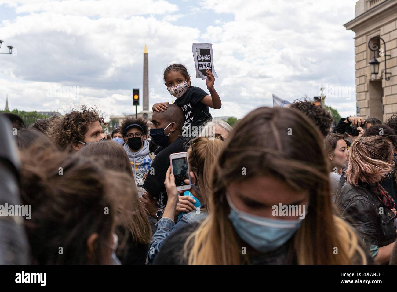 A child holds a sign saying "No justice no peace". Demonstrators gather in front of the U.S. Embassy at the call of the Black African Defense League (Ligue de Défense Noire Africaine) in memory of George Floyd and to protest against racism. Paris, France, June 6, 2020. Photo by Florent Bardos/ABACAPRESS.COM Stock Photo