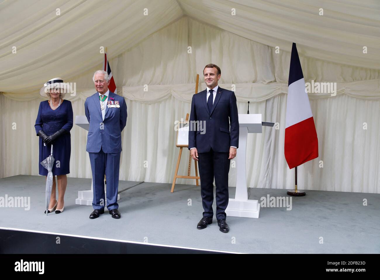 Britain's Camilla, Duchess of Cornwall (L), Britain's Prince Charles, Prince of Wales (C) and French President Emmanuel Macron (R) stand after a ceremony to present the Legion d'Honneur – France's highest distinction – to London for services during WW2 at Carlton Gardens in central London on June 18, 2020 during a visit to mark the anniversary of former de Gaulle's appeal to French people to resist the Nazi occupation. - Macron visited London on June 18 to commemorate the 80th anniversary of former French president Charles de Gaulle's appeal to French people to resist the Nazi occupation durin Stock Photo