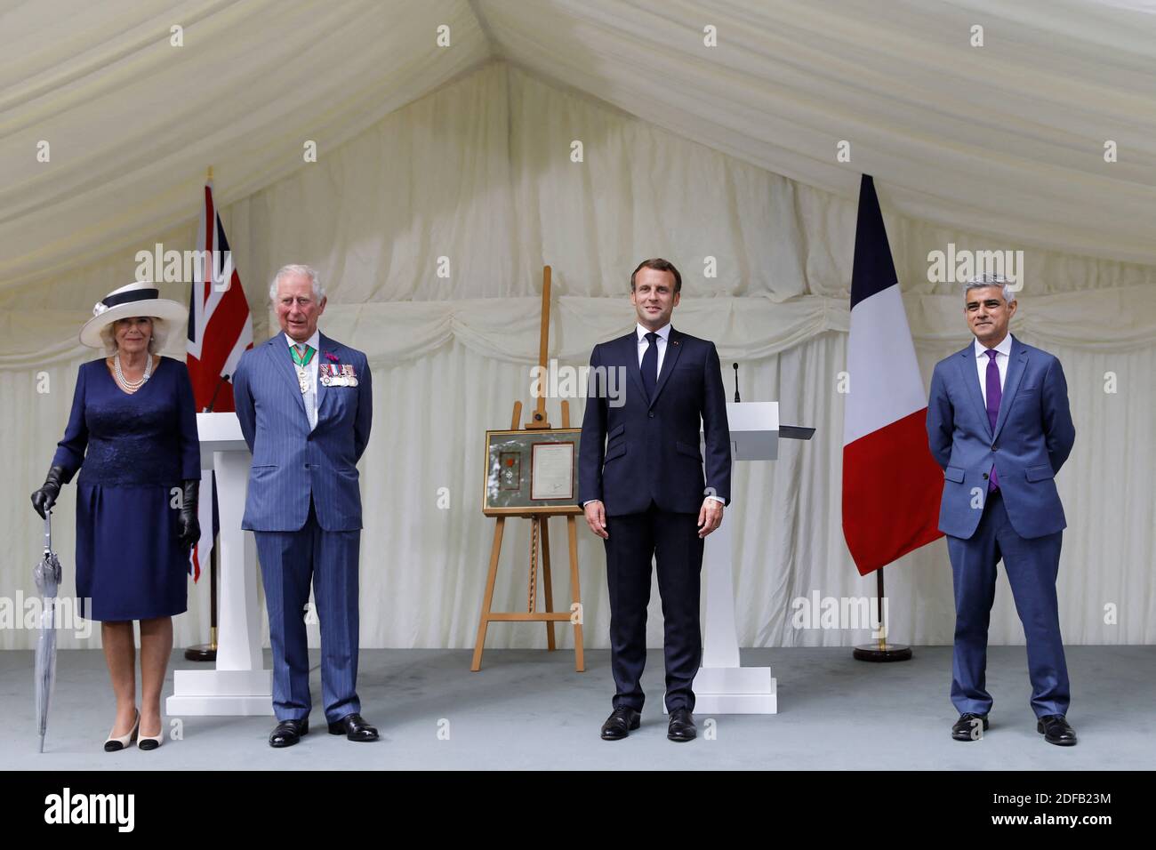 Britain's Camilla, Duchess of Cornwall (L), Britain's Prince Charles, Prince of Wales (2nd L) French President Emmanuel Macron (2nd R) and London Mayor Sadiq Khan (R) stand after a ceremony to present the Legion d'Honneur – France's highest distinction – to London for services during WW2 at Carlton Gardens in central London on June 18, 2020 during a visit to mark the anniversary of former de Gaulle's appeal to French people to resist the Nazi occupation. - Macron visited London on June 18 to commemorate the 80th anniversary of former French president Charles de Gaulle's appeal to French people Stock Photo