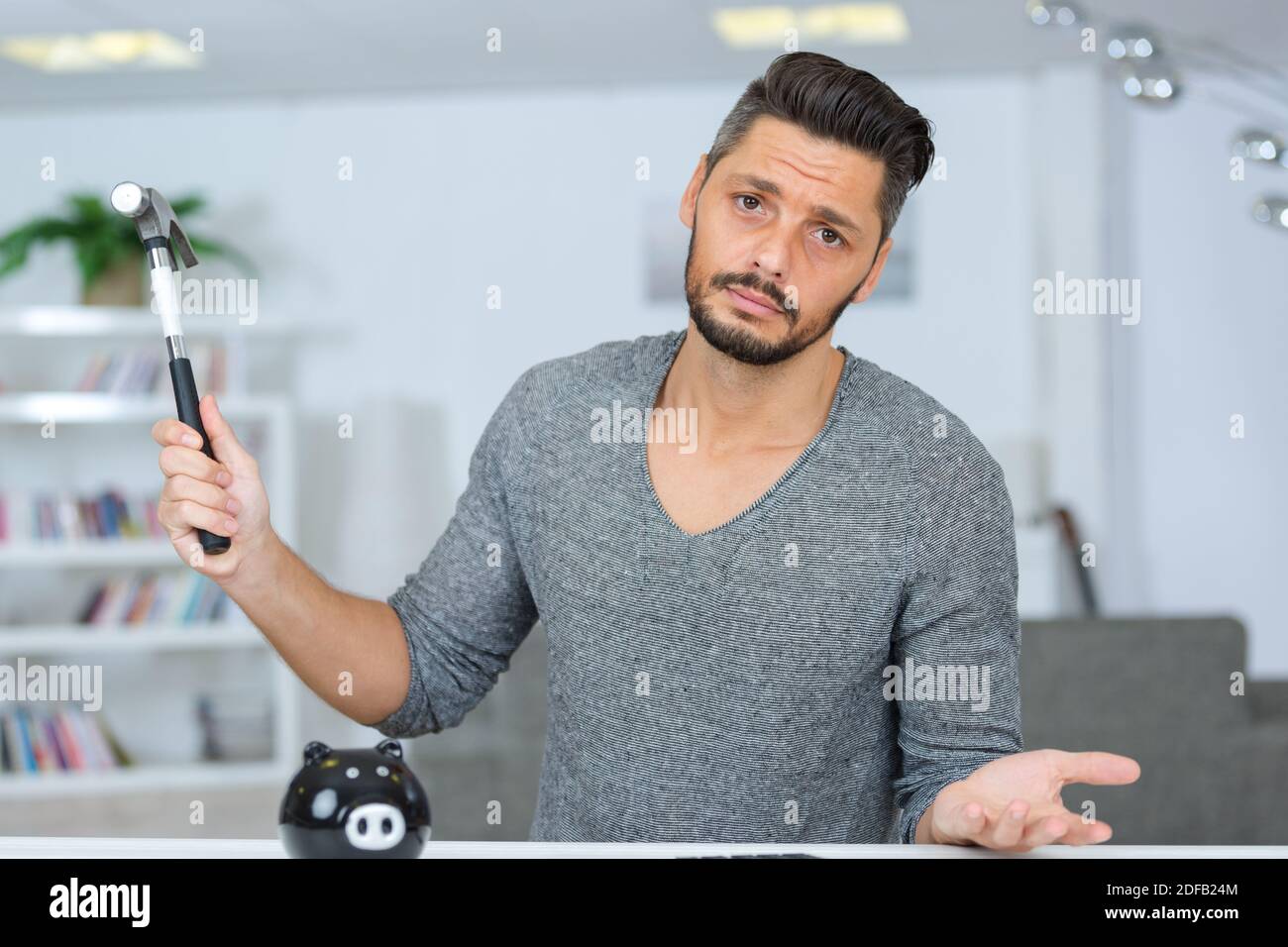 feeling sad in breaking the piggy bank Stock Photo - Alamy