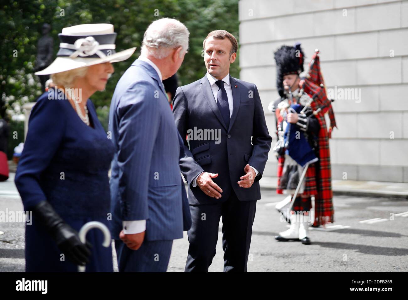 Britain's Camilla, Duchess of Cornwall (L), Britain's Prince Charles, Prince of Wales (C) and French President Emmanuel Macron (R) lay wreaths at the statue of former French president Charles de Gaulle at Carlton Gardens in central London on June 18, 2020 during a visit to mark the anniversary of former de Gaulle's appeal to French people to resist the Nazi occupation. - Macron visited London on June 18 to commemorate the 80th anniversary of former French president Charles de Gaulle's appeal to French people to resist the Nazi occupation during World War II. Photo by Tolga AKMEN/Pool/ABACAPRES Stock Photo