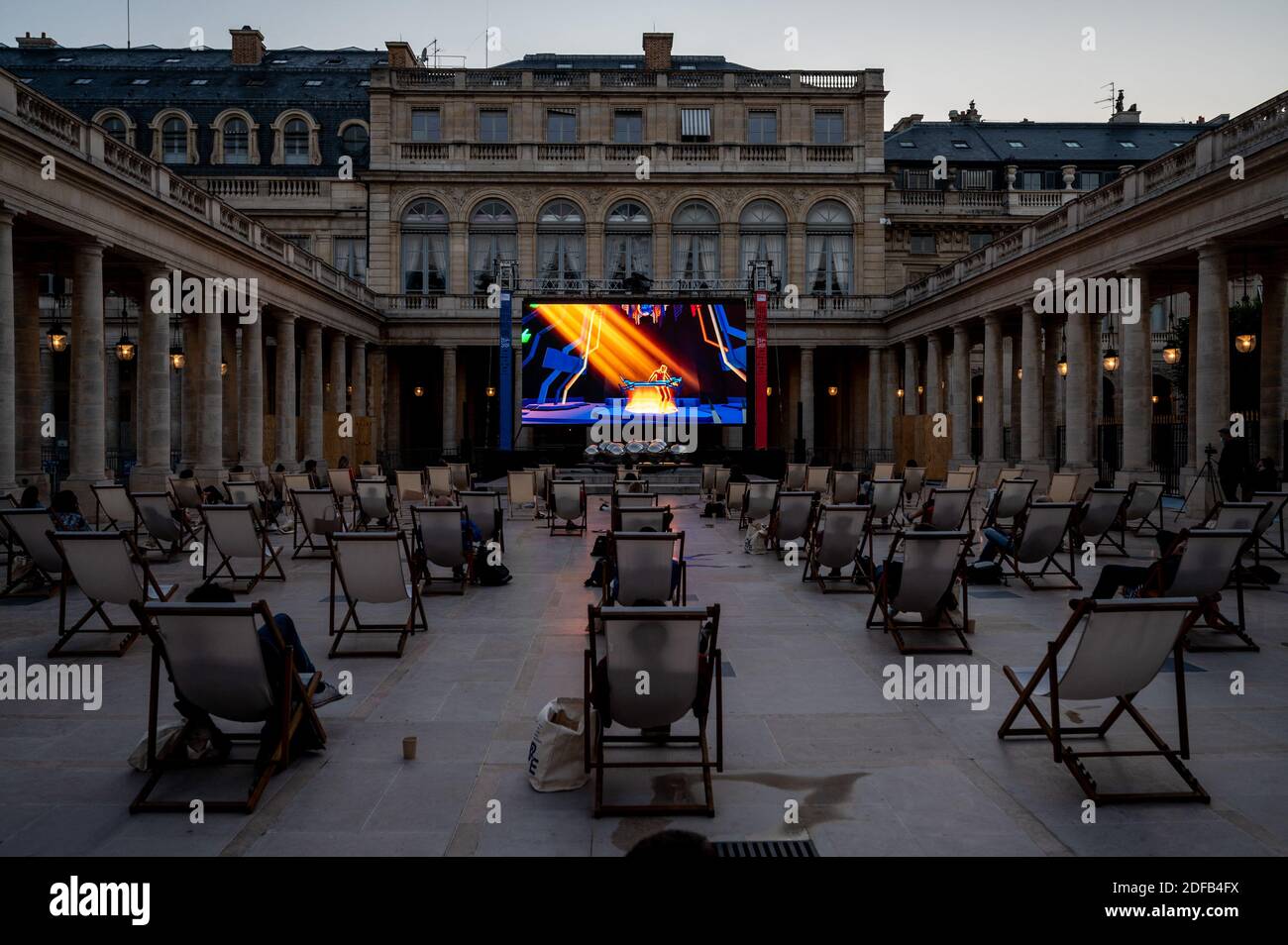 People attend first virtual reality live concert by Jean-Michel Jarre, in  the courtyard of Palais Royal, in Paris, France on June 21, 2020, as part  of celebrations of Music Day (or Fete