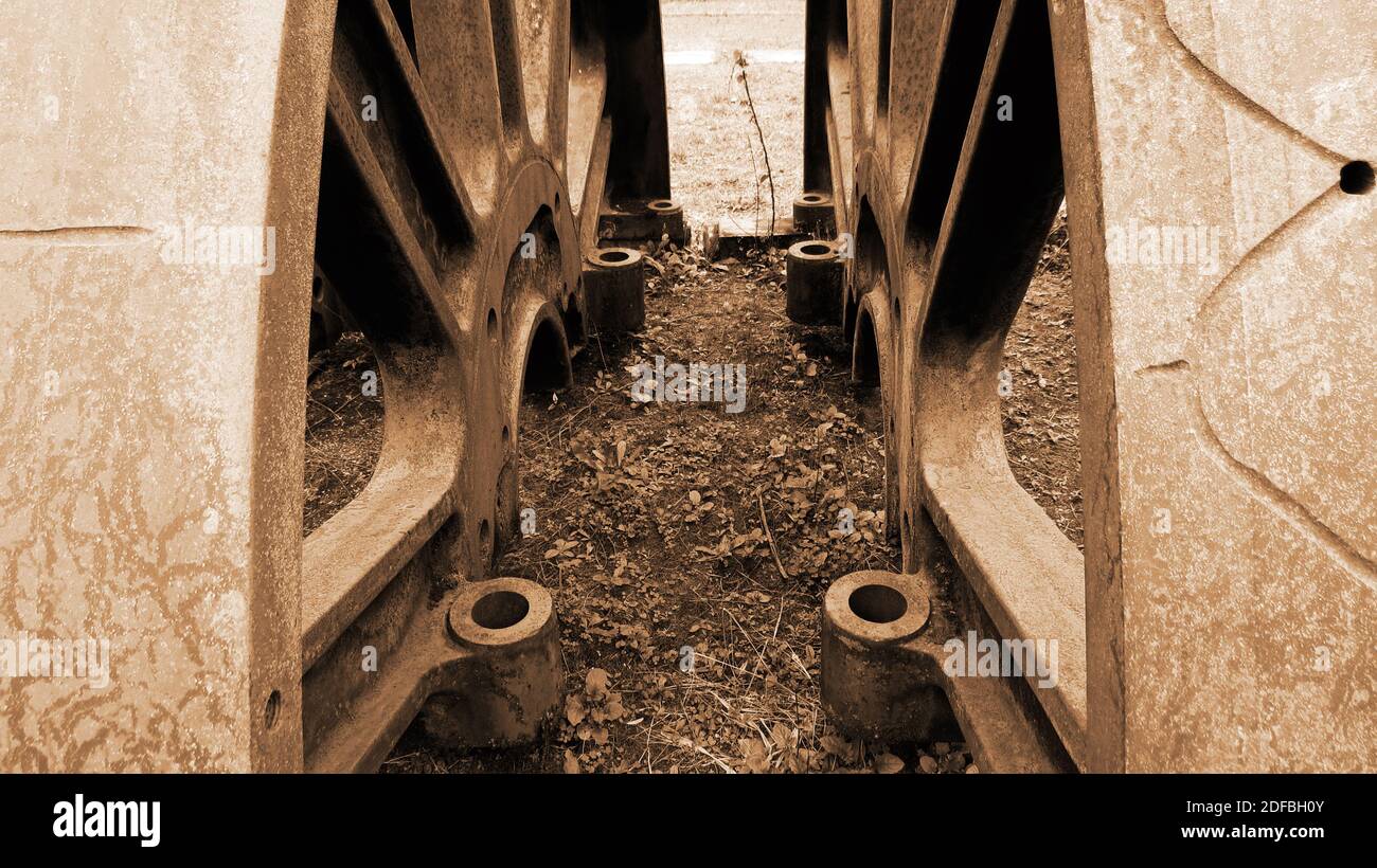 Two old and abandoned train's wheels side by side mirroring each other [Sepia colors] Stock Photo