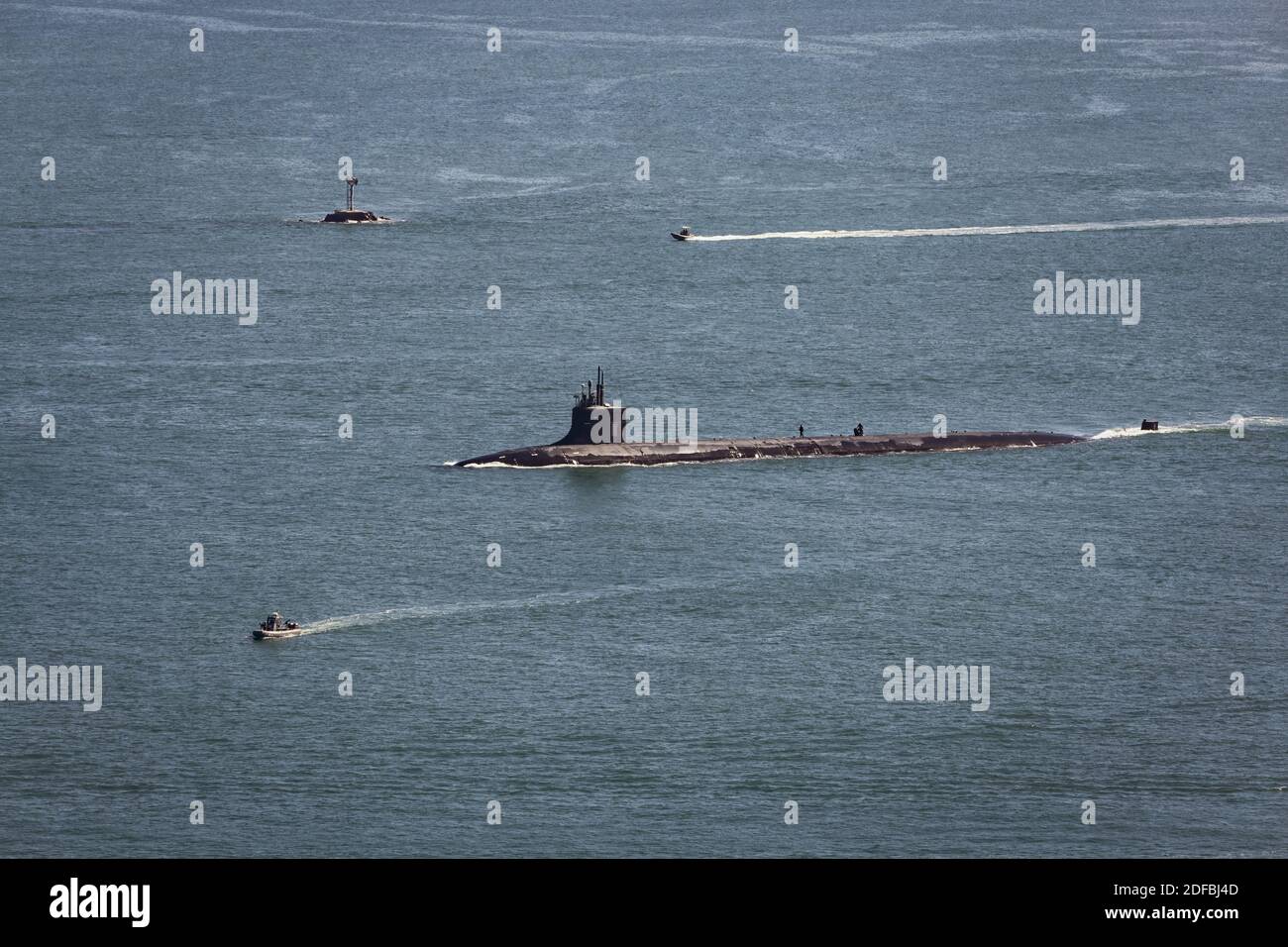 A US Navy submarine enters the breakwater at the harbor in San Diego, California. Stock Photo