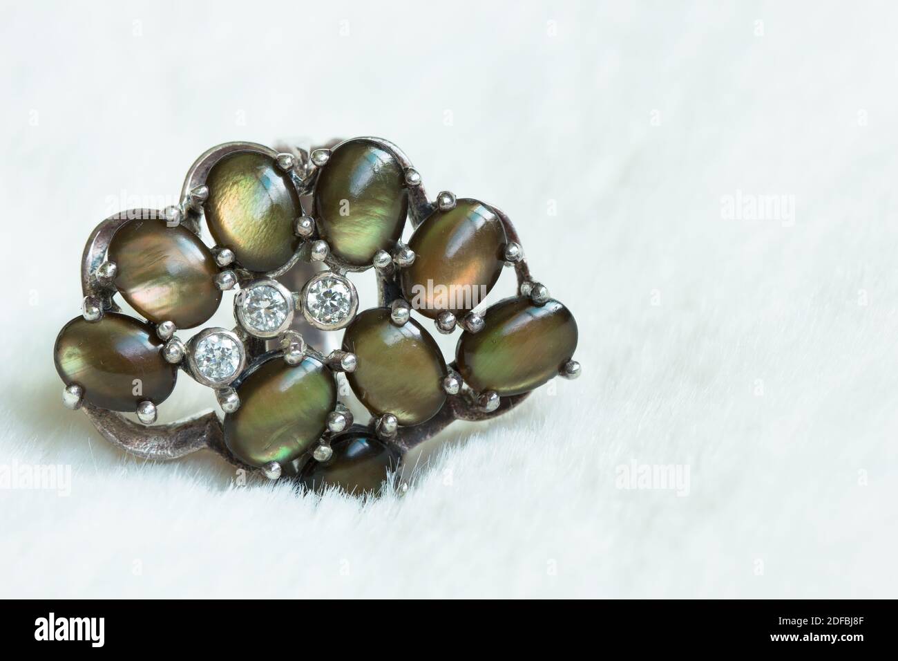 Green Stones On A Silver Ring Stock Photo