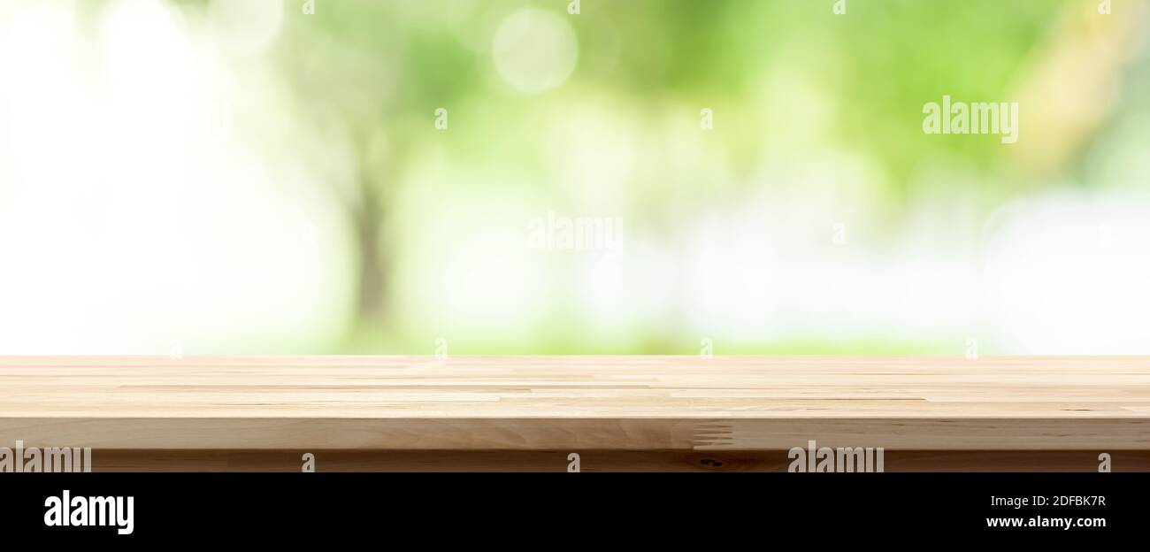 Wood table top on blur green background of trees in the park, panoramic banner - can be used for display or montage your products Stock Photo