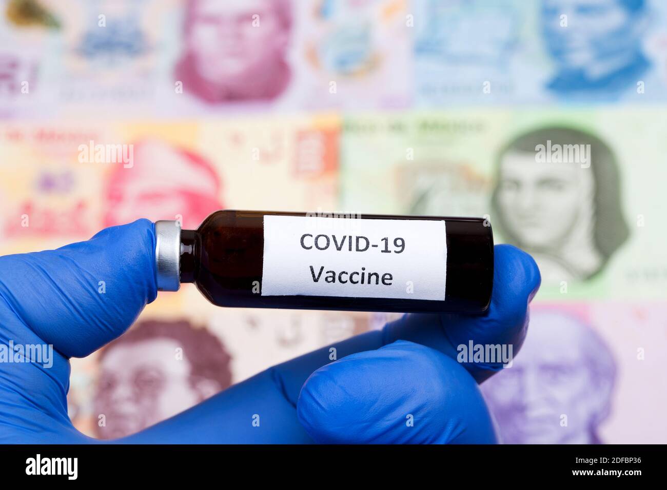 Vaccine against Covid-19 on the background of Mexican money Stock Photo