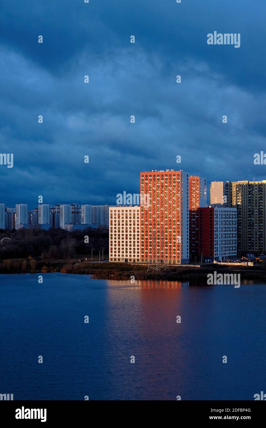 New colored residential buildings with reflection in lake Stock Photo