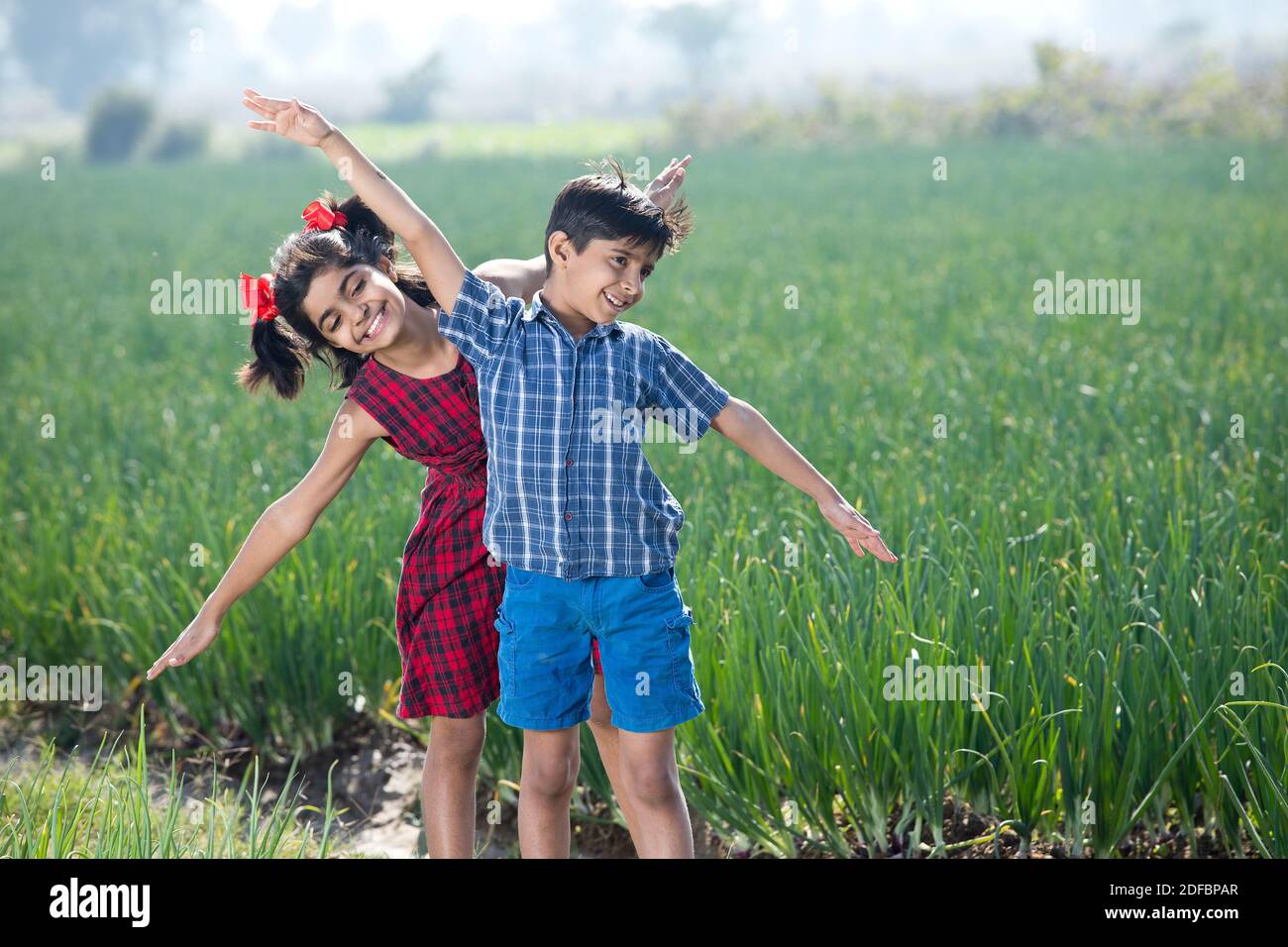 Happy children having fun in agricultural field Stock Photo - Alamy