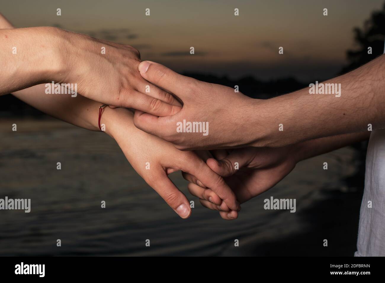 Men's and women's hands of lovers, two men gently hold hands. Love forever, touch and romance Stock Photo