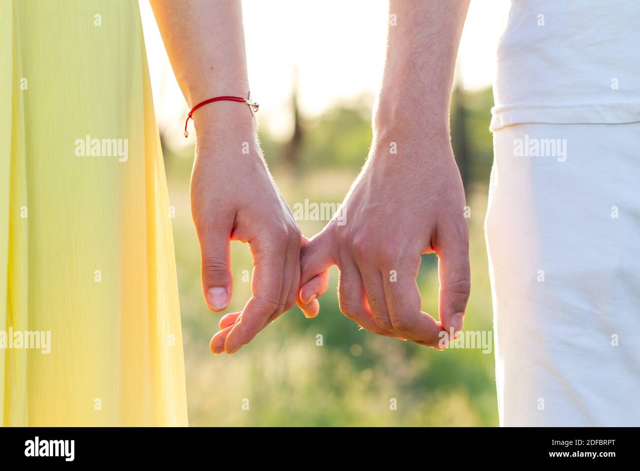 Men's and women's hands of lovers, two men gently hold hands. Love forever, touch and romance Stock Photo