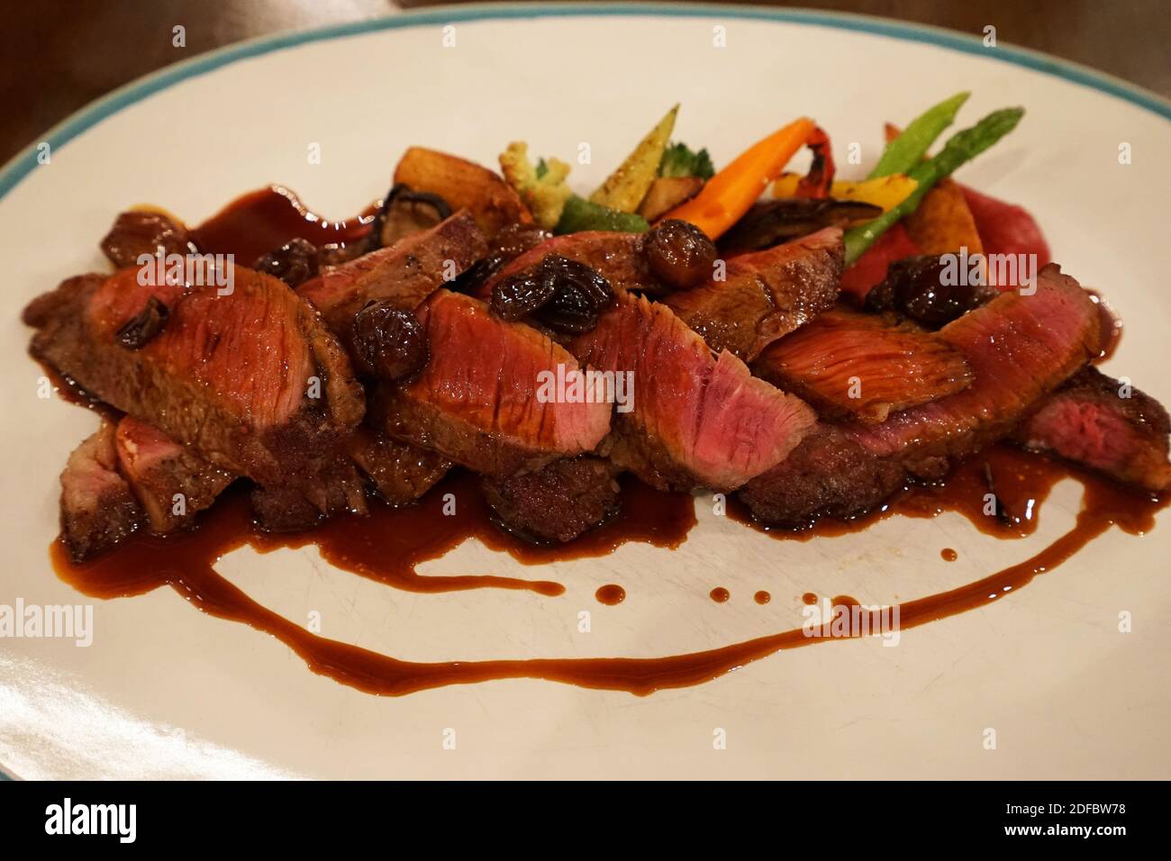 Close up Togliata di Manzo, Rib eye (black angus) steak with red wine and shallot sauce served with dally roasted vegetables Stock Photo