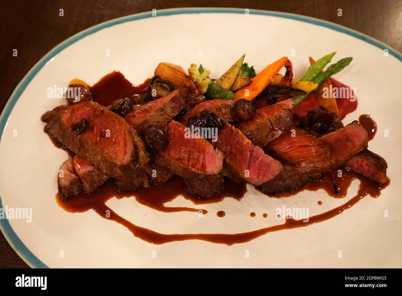 Close up Togliata di Manzo, Rib eye (black angus) steak with red wine and shallot sauce served with dally roasted vegetables Stock Photo