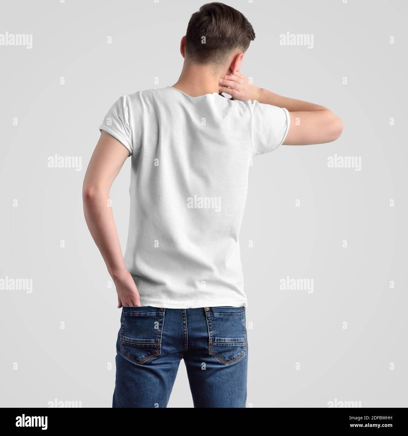 Template of a white men's t-shirt on a young guy in blue jeans, rear view. Mockup fashion clothes for advertising in the online store and presentation Stock Photo