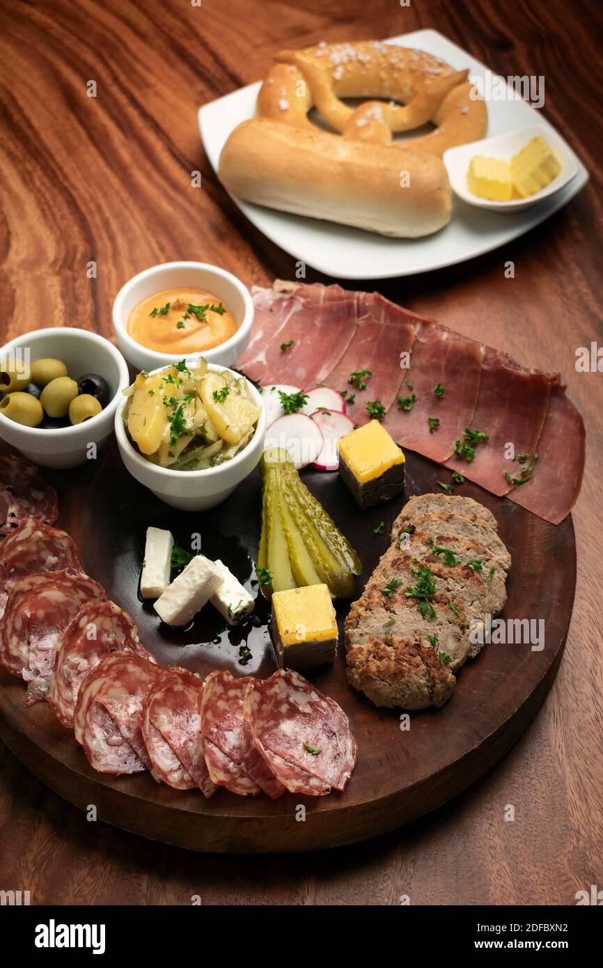 german cold cuts tapas snack platter with meats and bread on wood table background Stock Photo