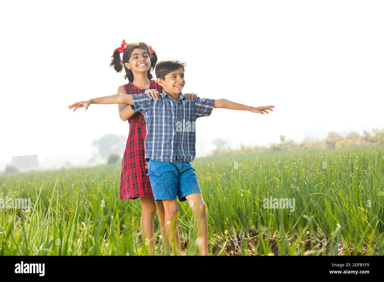 Happy children having fun in agricultural field Stock Photo - Alamy