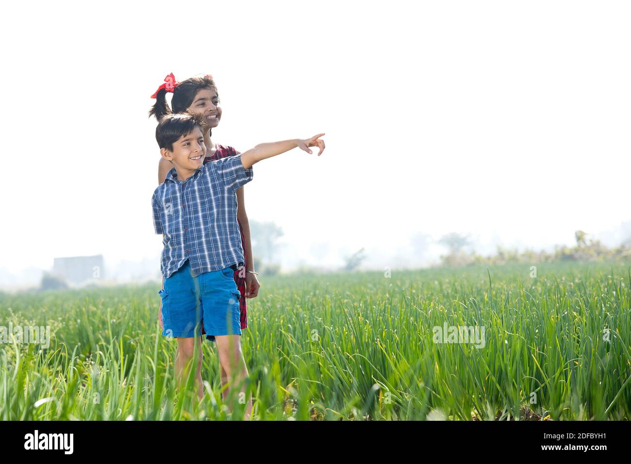 Happy children having fun in agricultural field Stock Photo - Alamy