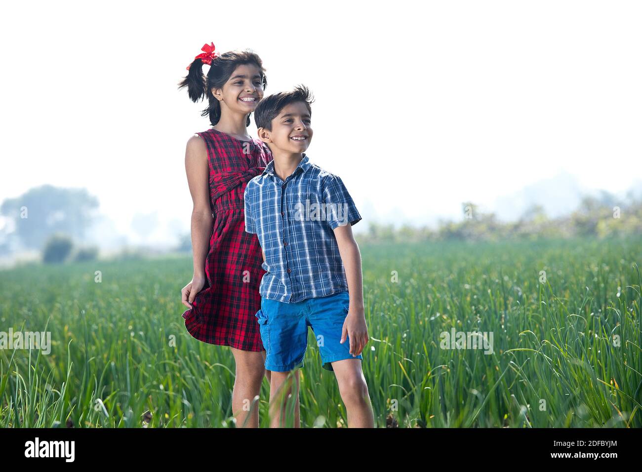 Happy children having fun in agricultural field Stock Photo - Alamy