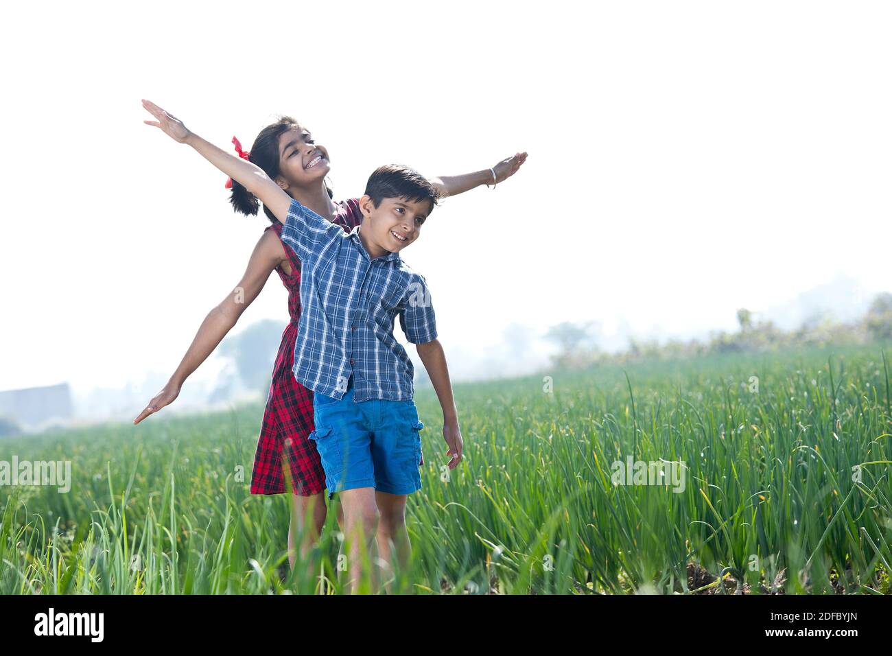 Happy children having fun in agricultural field Stock Photo - Alamy