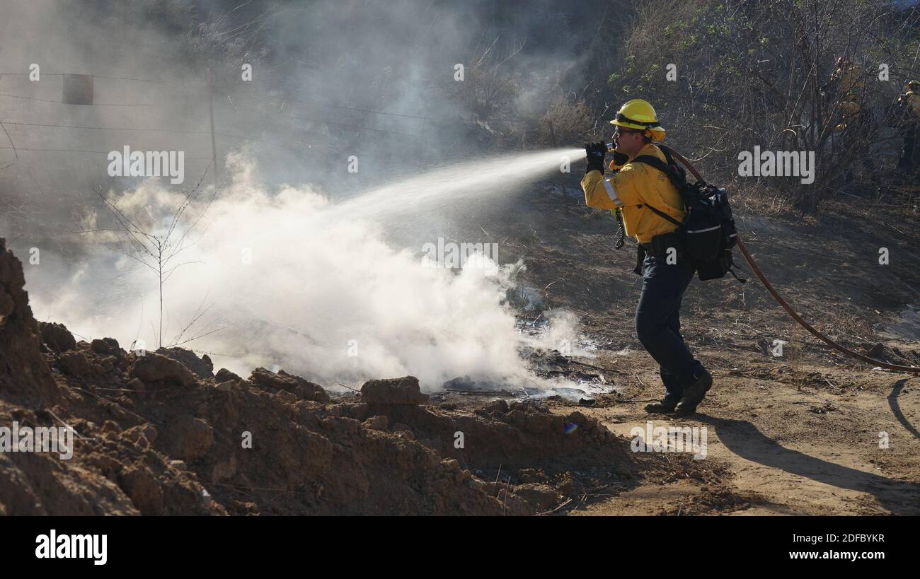 Irvine, USA. 3rd Dec, 2020. A firefighter battles the wildfire near Irvine, California, the United States, on Dec. 3, 2020. A wind-driven wildfire occurred near Irvine, a city with a significant Chinese-American population, forcing hundreds of people to flee their homes on Thursday. Credit: Zeng Hui/Xinhua/Alamy Live News Stock Photo