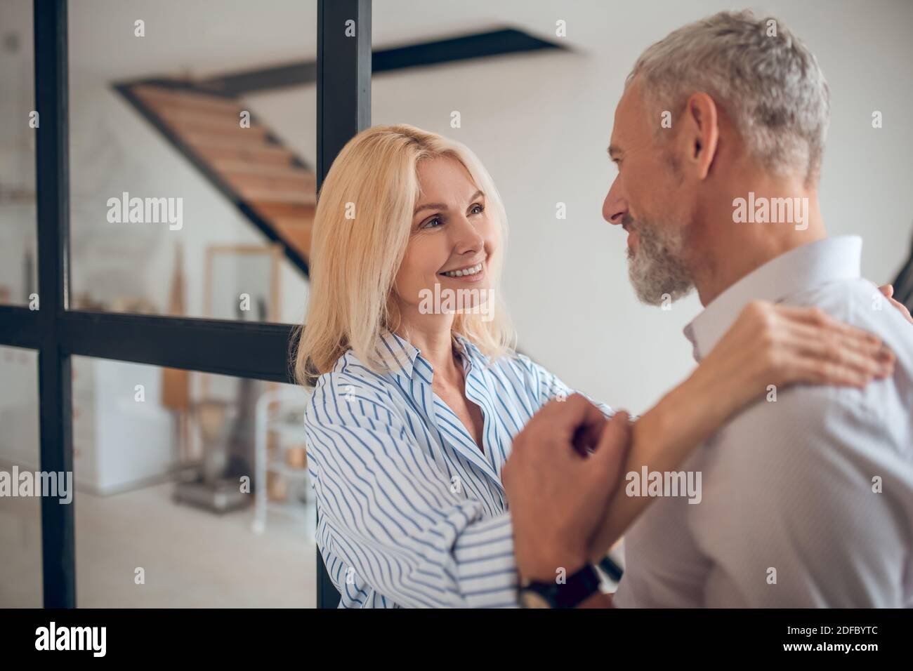 Blonde woman hugging her boyfriend and smiling happily Stock Photo - Alamy