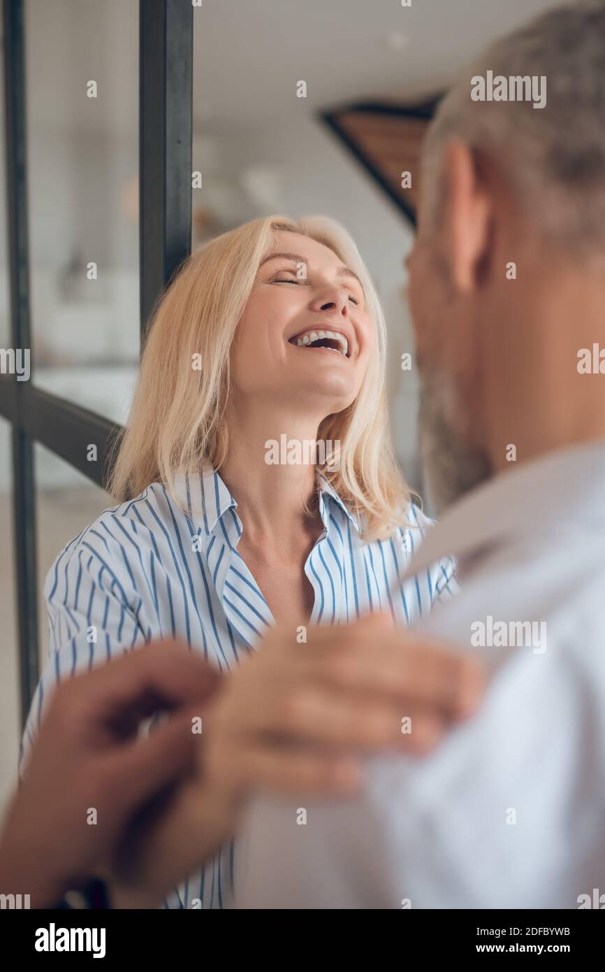 Blonde woman hugging her boyfriend and smiling happily Stock Photo - Alamy