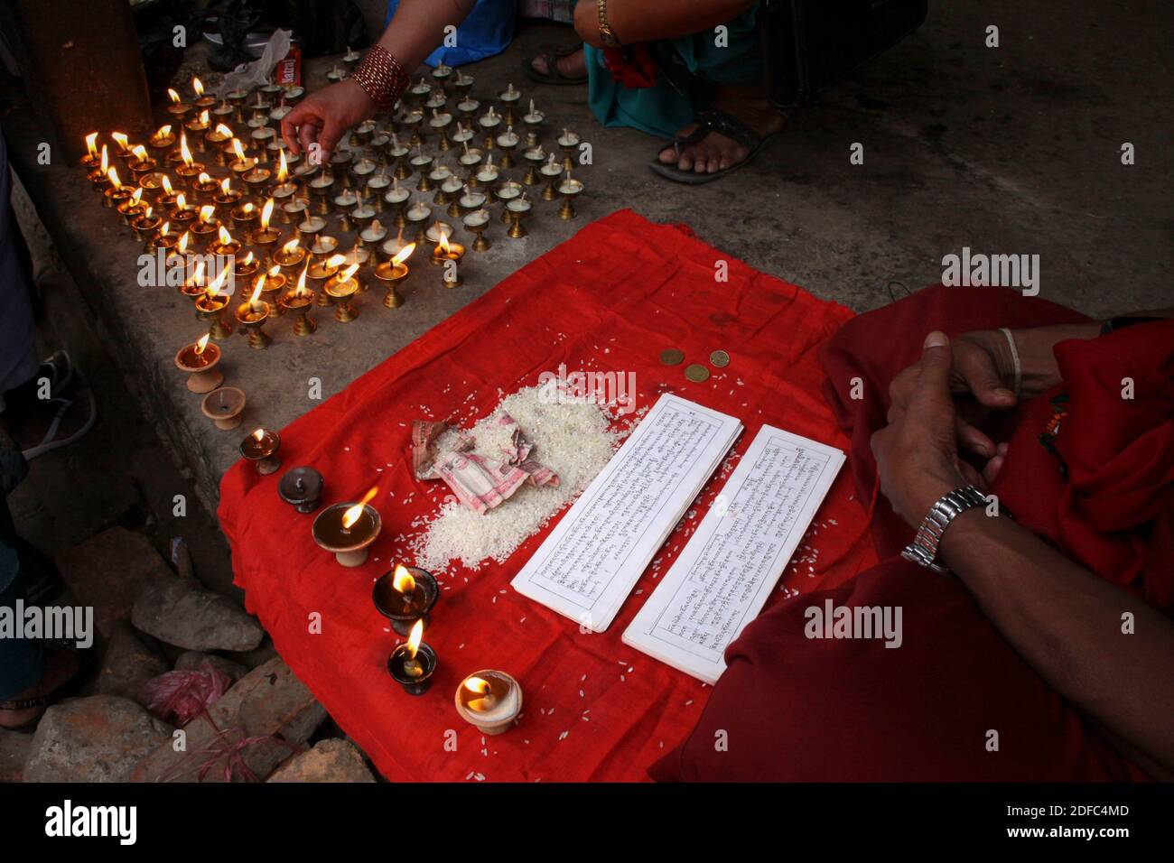 Nepal, hands of a Buddhist monk meditating in the streets of Patan Stock Photo