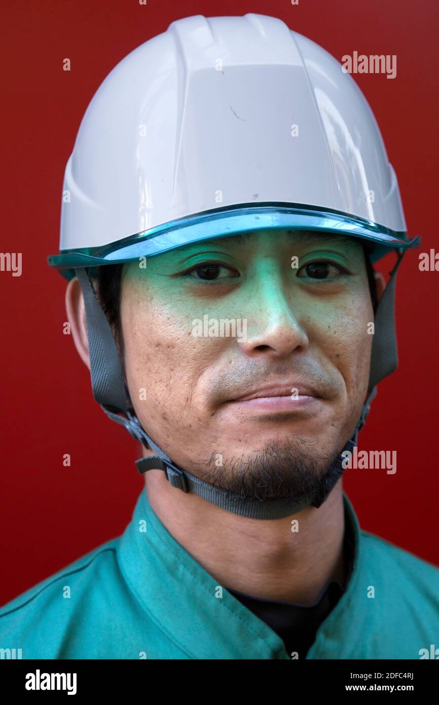 Japan, Japanese worker with helmet in Tokyo Stock Photo