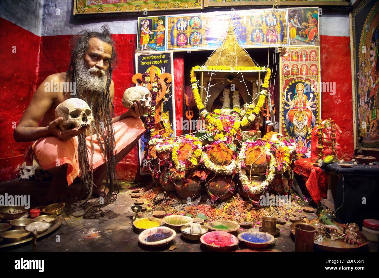 India, portrait of Aghori cannibal sadhu holy man in front of decorated temple in Varanasi Stock Photo