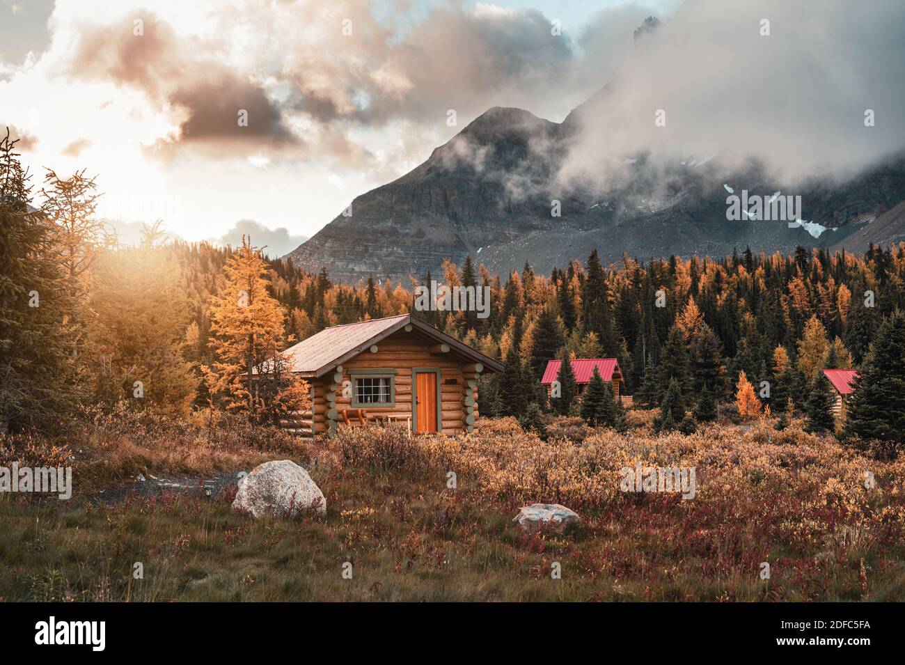 Wooden huts with sunshine in autumn forest at Assiniboine provincial ...