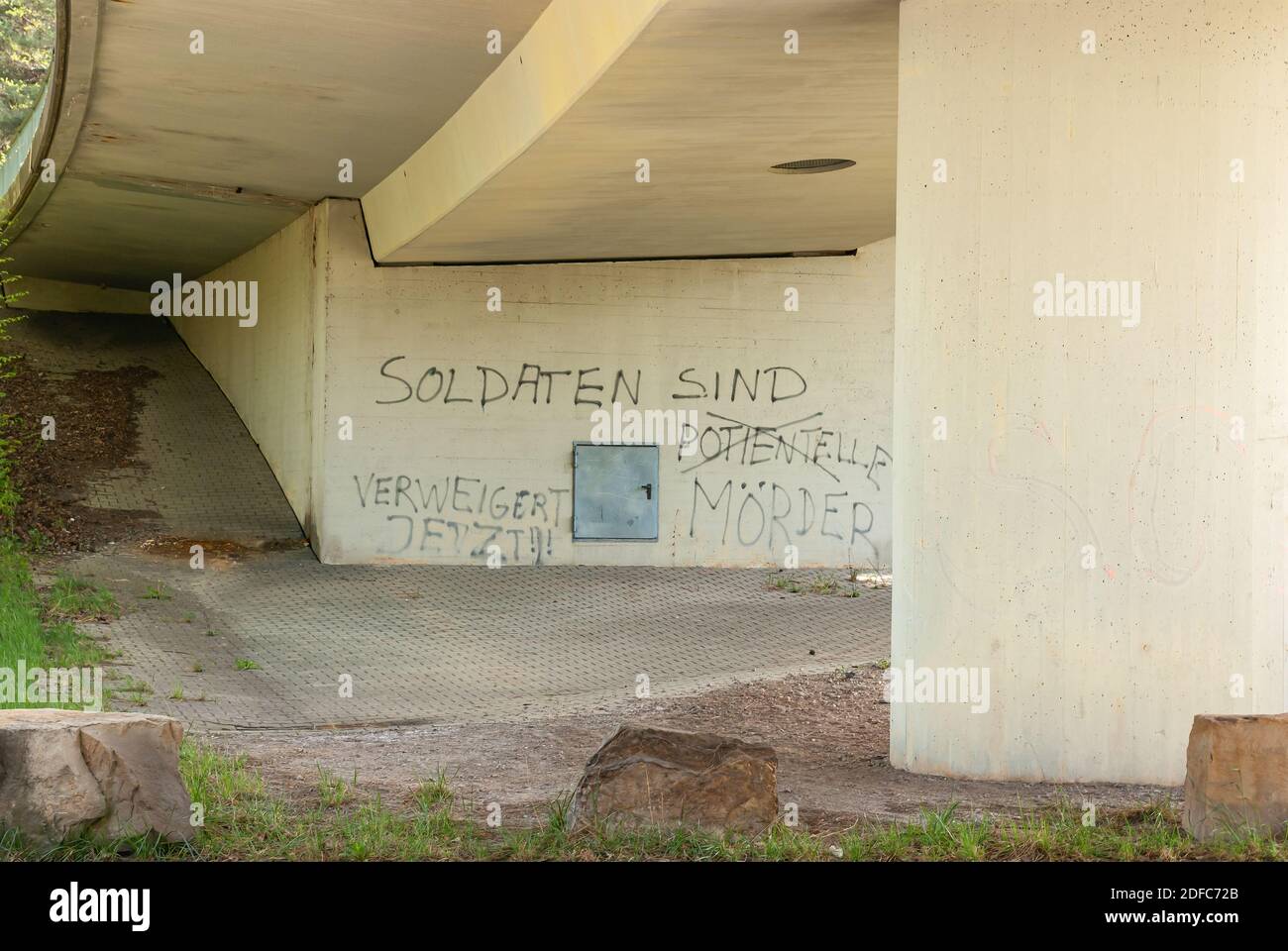 Bridge with graffito on soldiers in German language at a bridge pier. Stock Photo