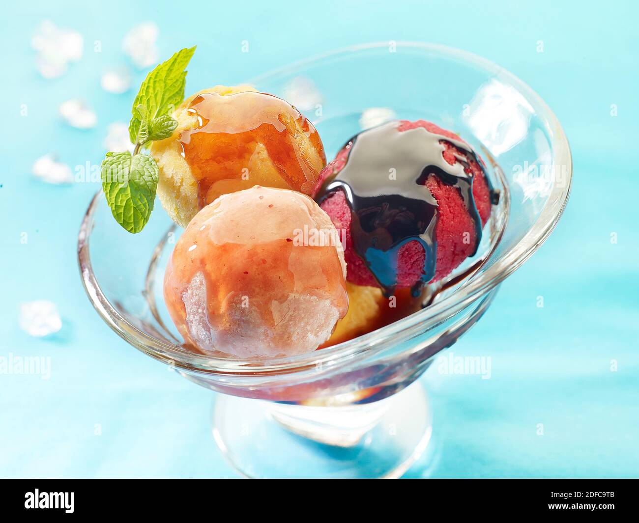 Cup of ice cream balls in three flavors coated with chocolate Stock Photo