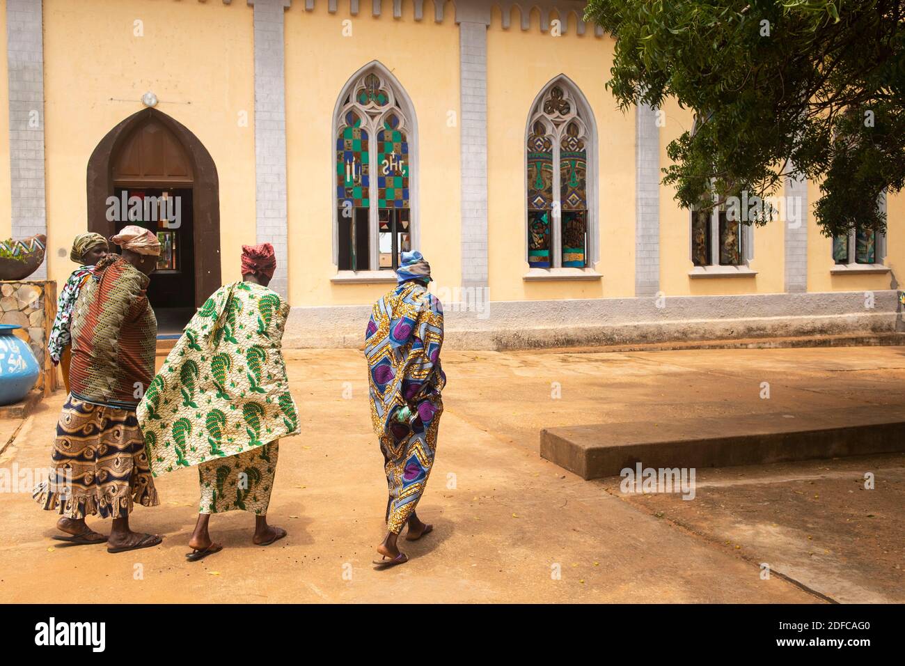 Togo, Togoville, women walking in front of Notre dame du lac cathedral Stock Photo
