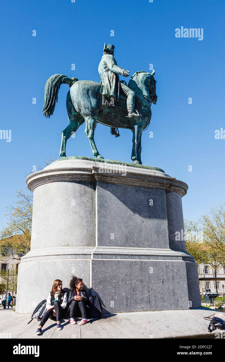 France, Vendee, La Roche sur Yon, two girls sitting before Napoleon statue Stock Photo