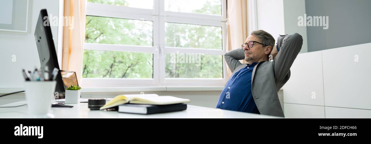 Successful Businessman Leaning Back On A Chair Stock Photo Alamy