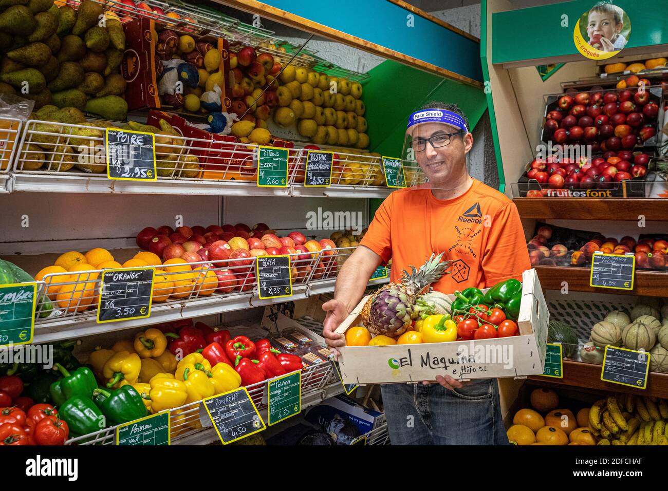 HASSAN IN HIS GROCERY SHOP IN FRONT OF THE FRUIT AND VEGETABLE STAND, EURE, NORMANDY, FRANCE, EUROPE Stock Photo