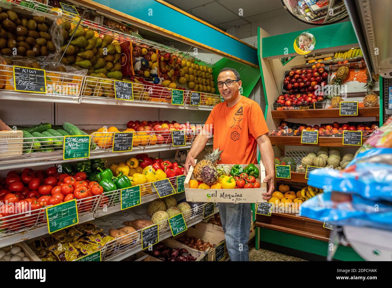 HASSAN IN HIS GROCERY SHOP SURROUNDED BY HIS FRUIT AND VEGETABLES, EURE, NORMANDY, FRANCE, EUROPE Stock Photo