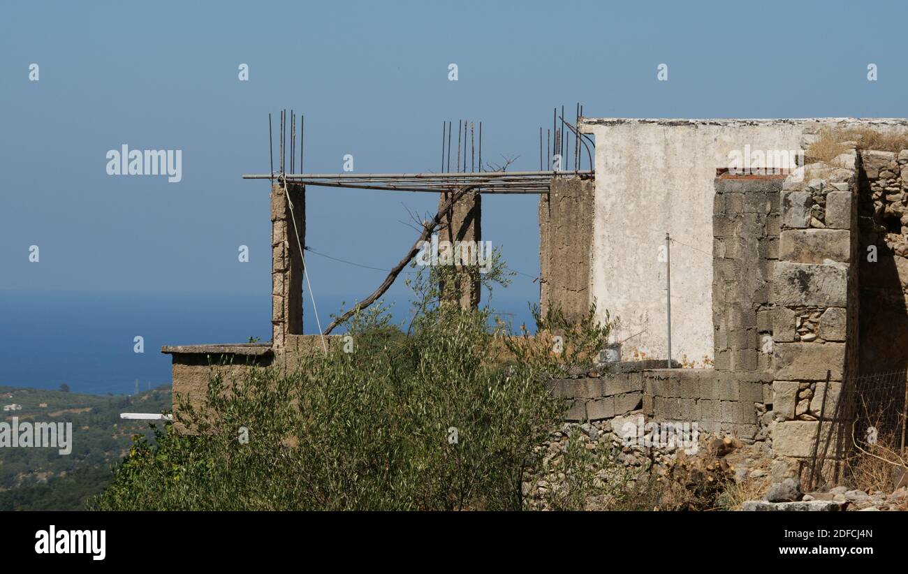 A part of an old ruined building on a high mountain on uncloud sky ...