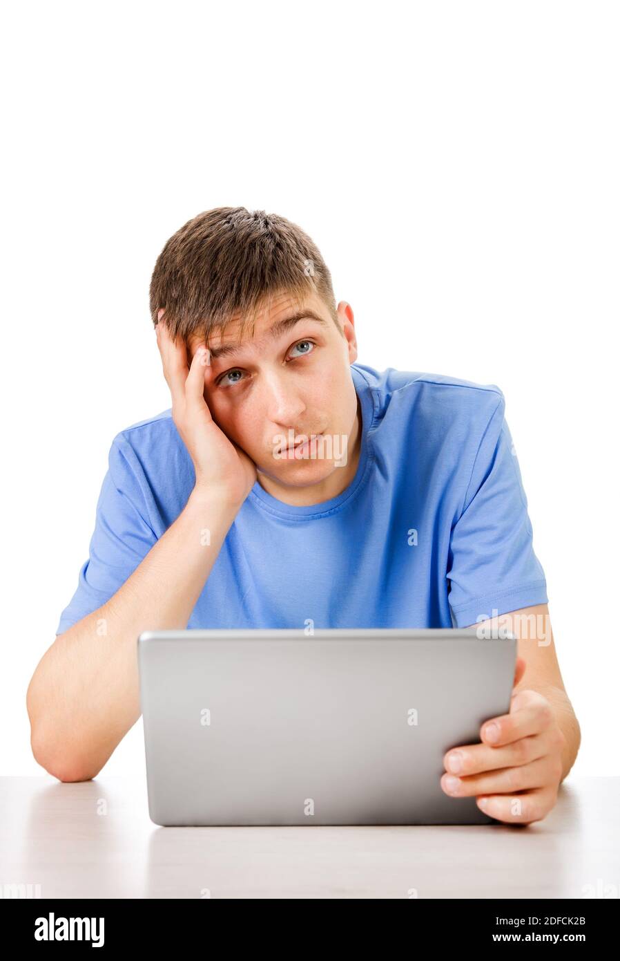 Pensive Young Man with Tablet Computer Isolated on the White Background Stock Photo