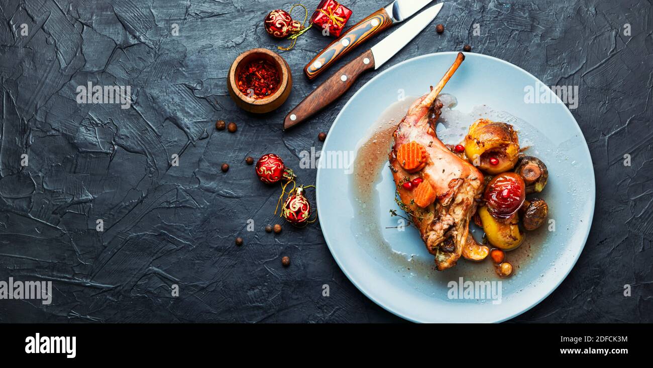 Braised rabbit meat with fruits.Baked meat for the Christmas table. Christmas dish. Stock Photo