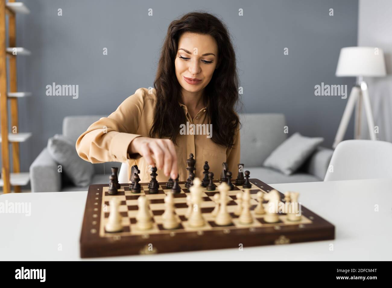 Woman Playing Chess Online Using Video Conference Call Stock Photo